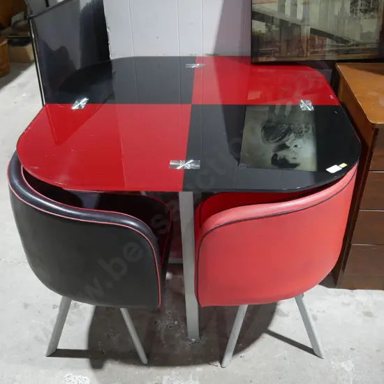 Red and black glass top table and four chairs