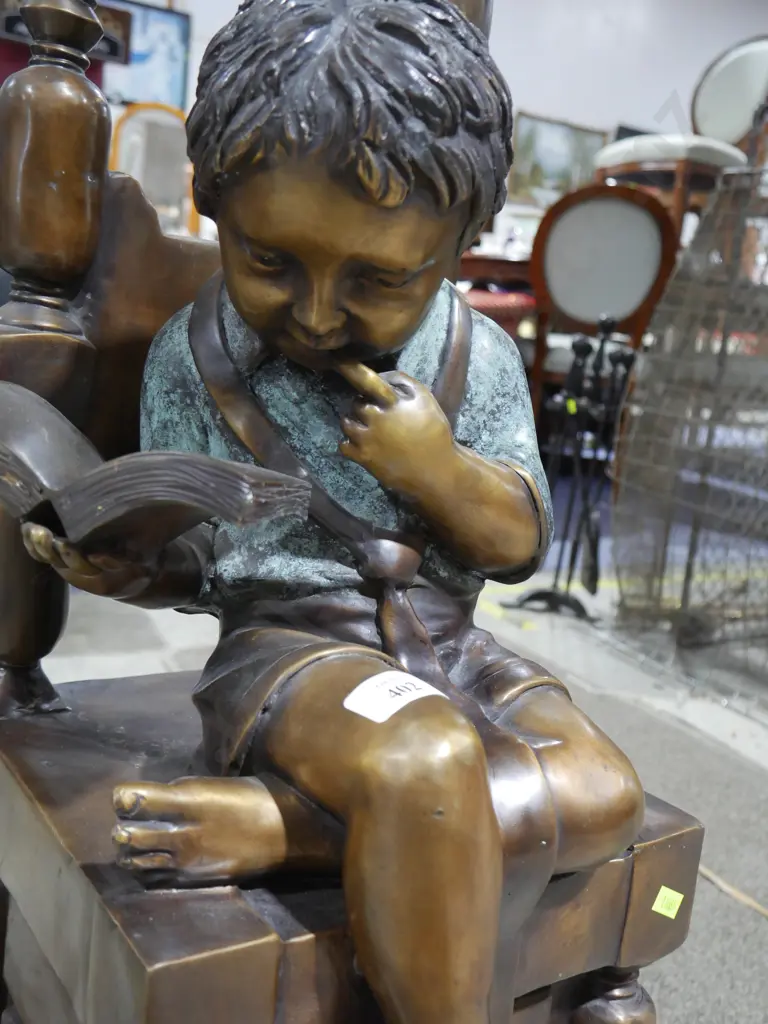 Metal reading boy on chair Image 1++
