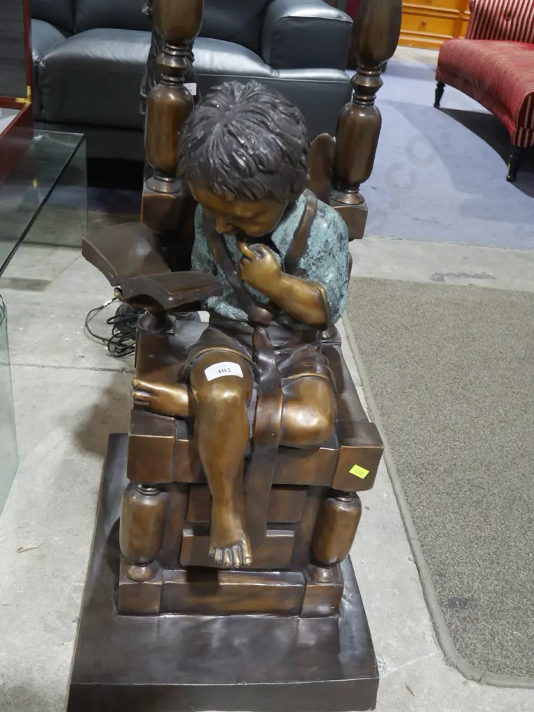 Metal reading boy on chair Image 1++