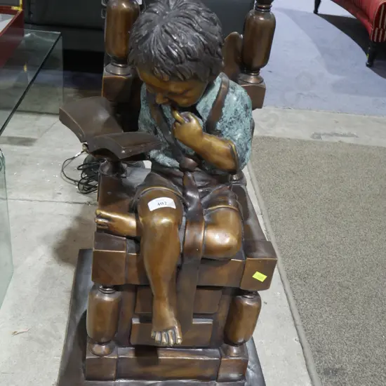 Metal reading boy on chair