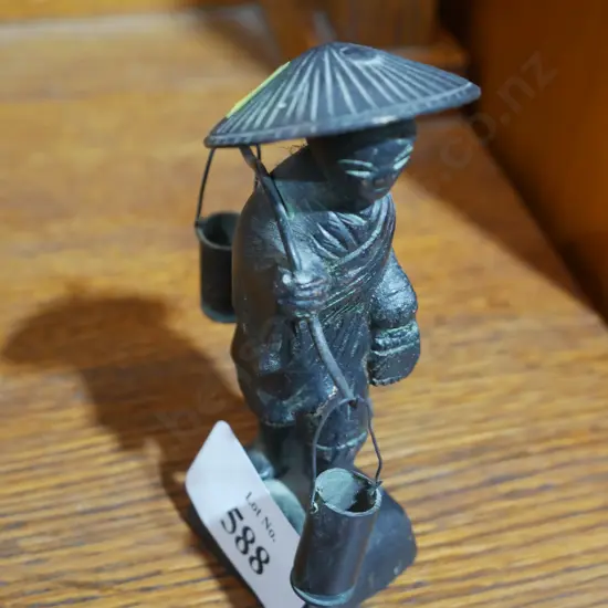 Oriental water carrier figurine