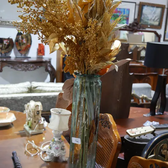 Tall glass vase and artificial plants