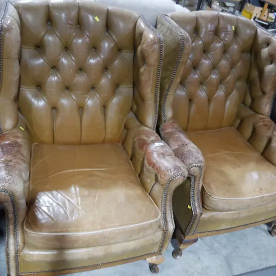 Pair of leather deep button armchairs
