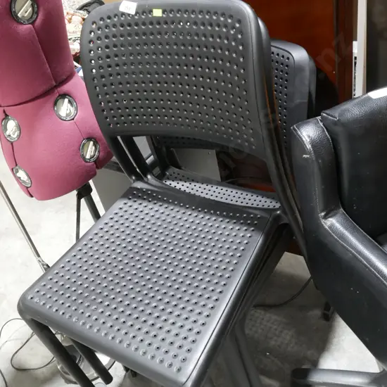 4 black plastic chairs
