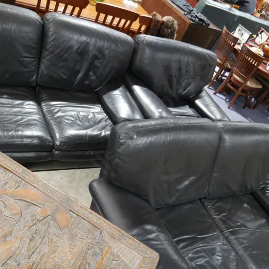 Three-piece black leather lounge suite