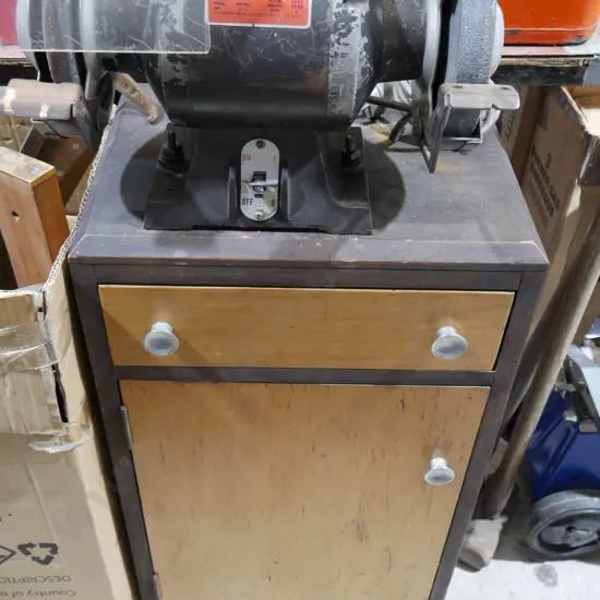 Skil bench grinder on cupboard
