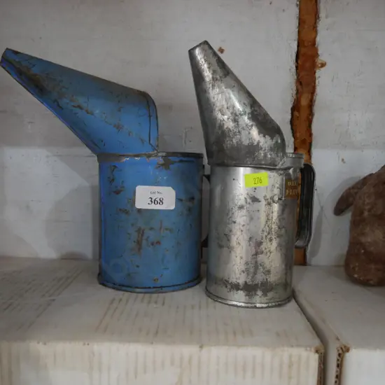 Two oil cans