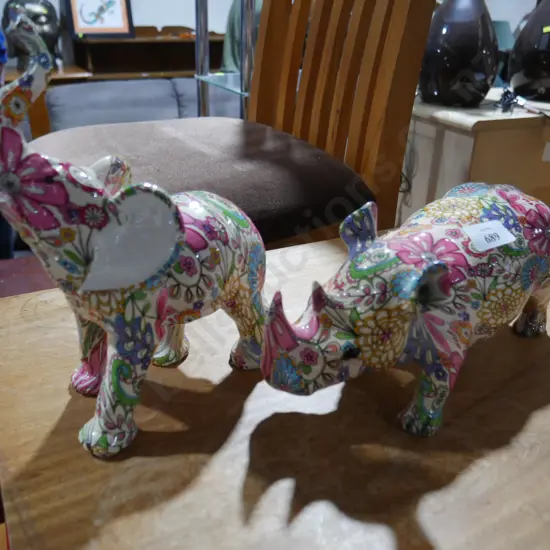 Floral rhino and elephant figurines