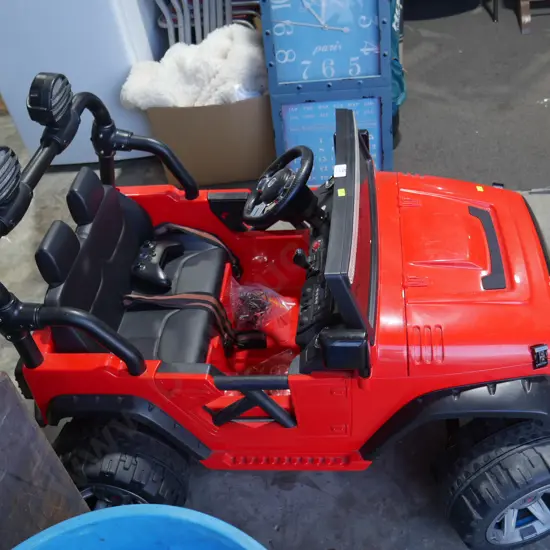 Childs red Jeep ride-on electric vehicle