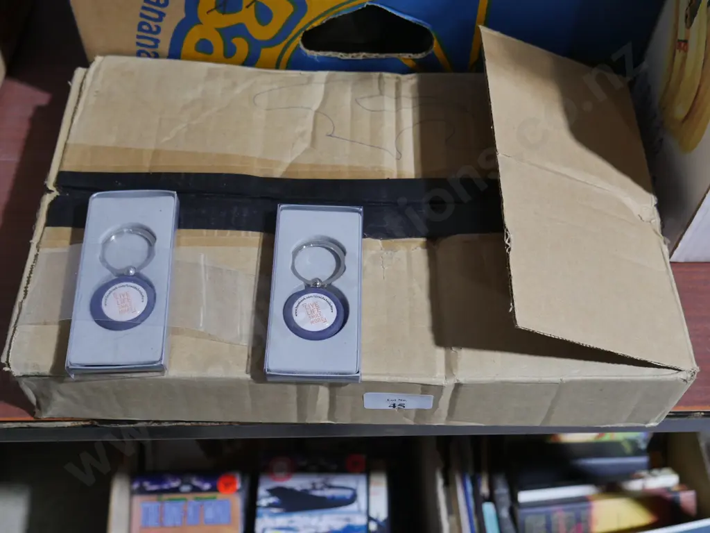 Box of "live life smile more" key chains Image 1++