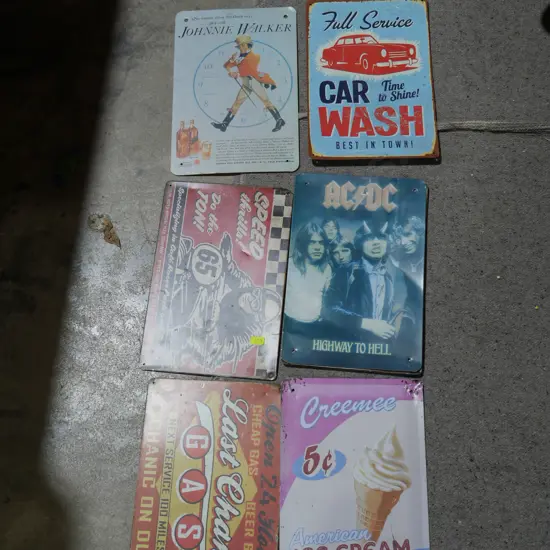 Assorted tin signs