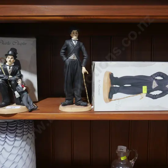 2 Charlie Chaplin figurines