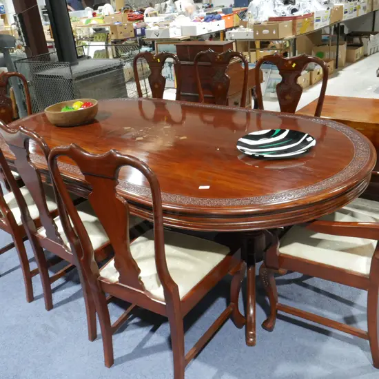 Ornate carved dining table and 8 chairs