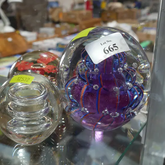 Three glass paper weights