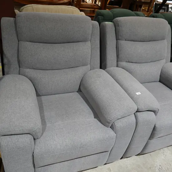 2 grey lazy boy chairs