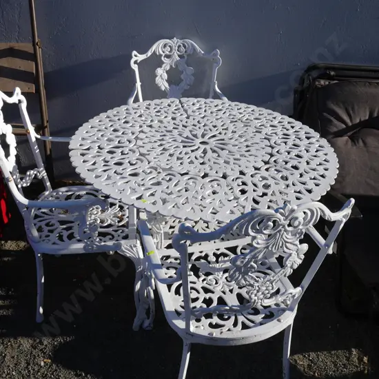Round metal table and three chairs