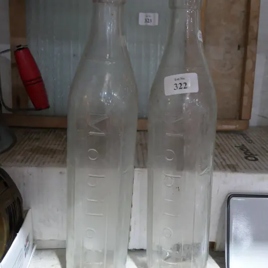 2 glass mobil oil bottles