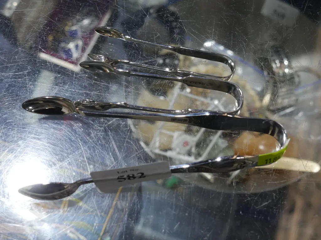 Three pairs of sterling silver sugar tongs Image 1++