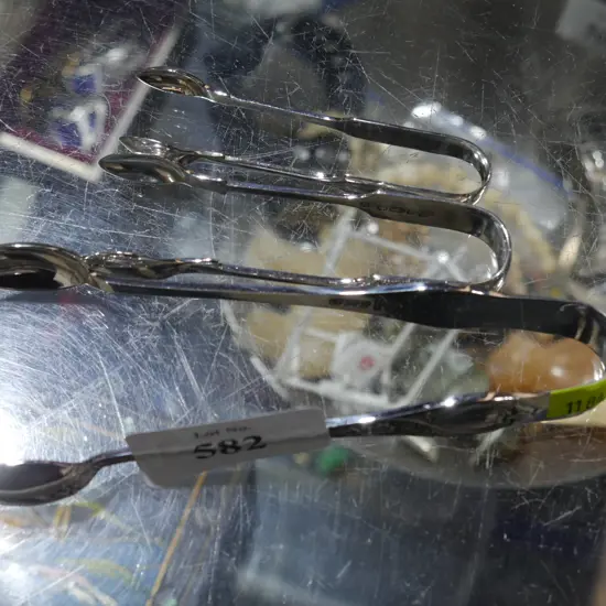 Three pairs of sterling silver sugar tongs