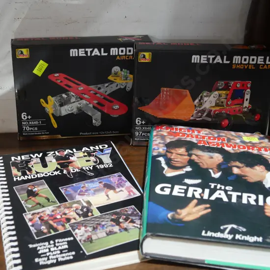 Metal model plane and shovel car, All Blacks books