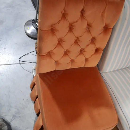 Orange deep buttoned bedroom chair