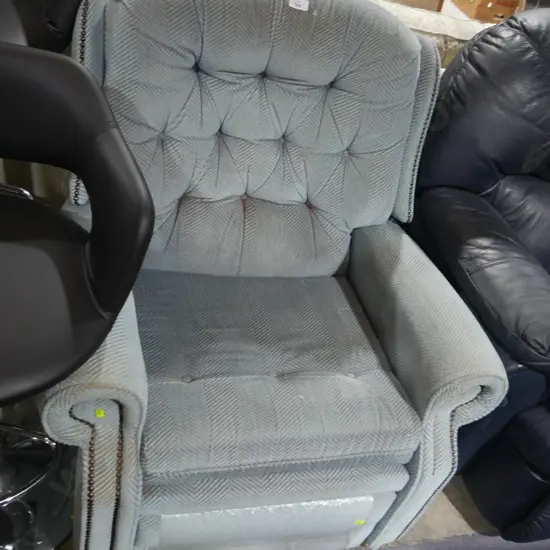 Deep buttoned recliner arm chair
