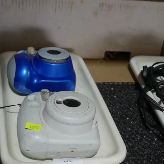 2 polaroid cameras