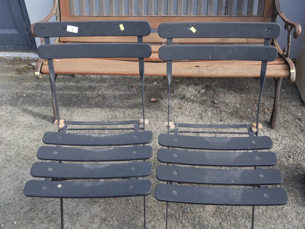 2 black folding chairs Image 1++