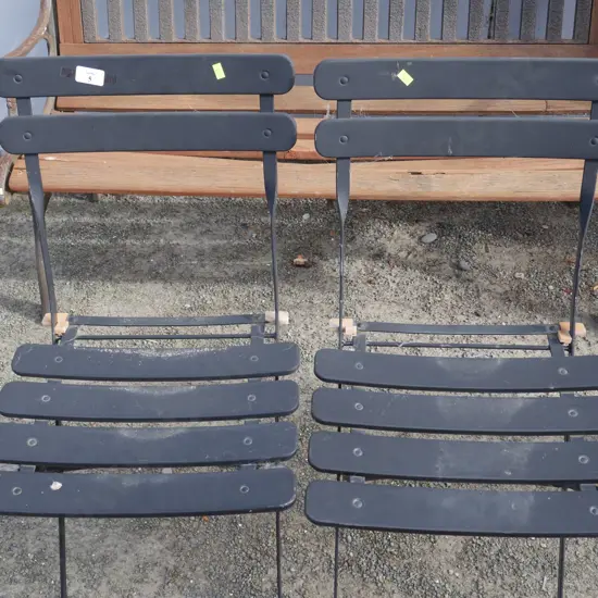 2 black folding chairs