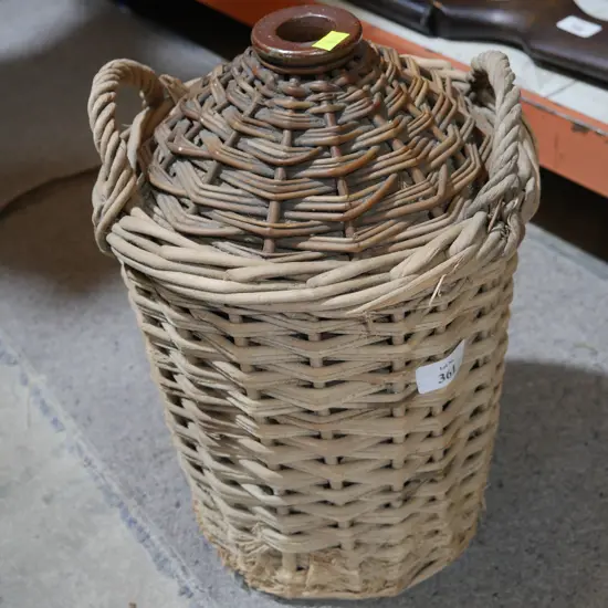 Wicker covered stone jar