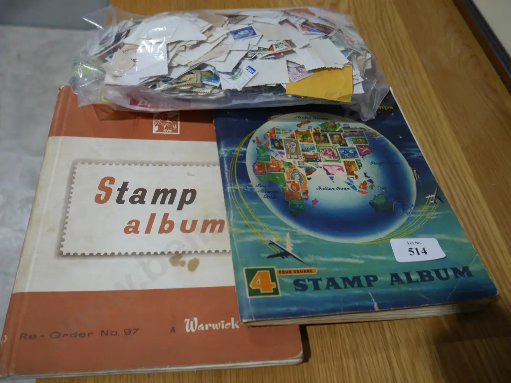 2 albums and bag óf stamps Image 1++