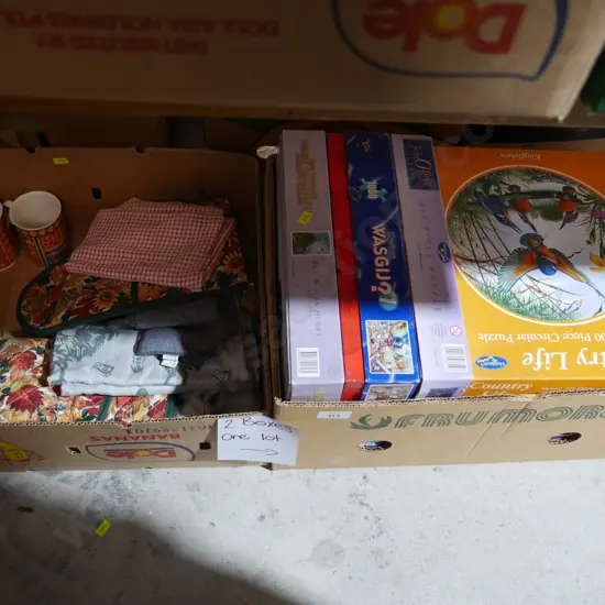 Two boxes of jigsaw puzzles etc