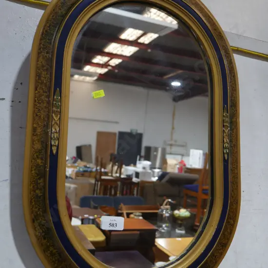 Oval framed mirror