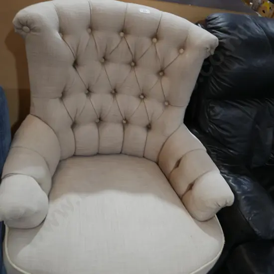 Deep buttoned armchair on casters