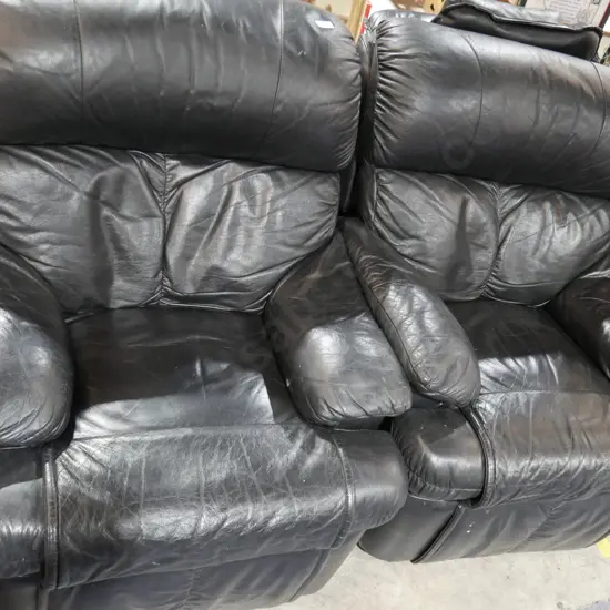 Pair of black leather recliner armchairs
