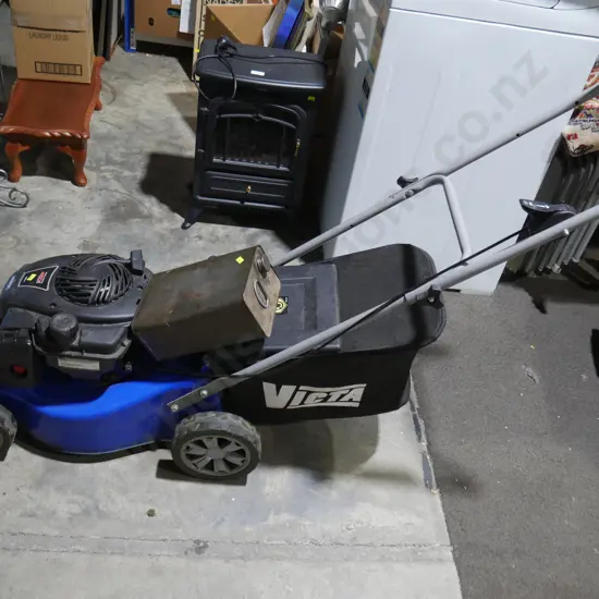 Victa lawnmower and petrol tin