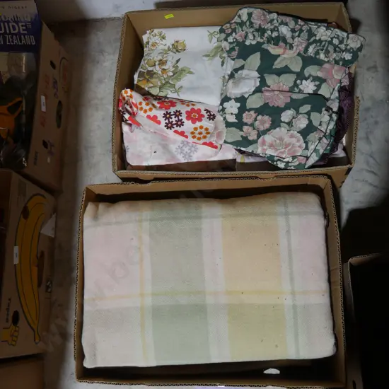Two boxes of material, blankets etc