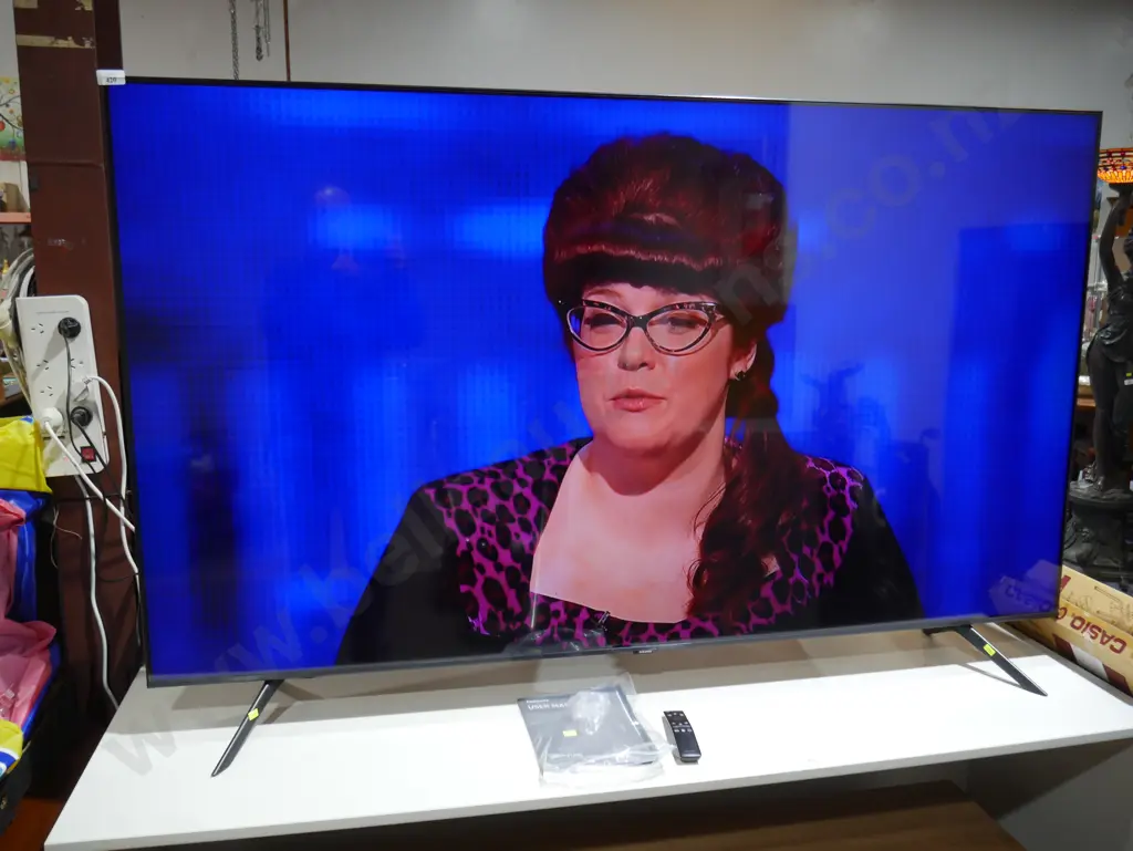 Samsung 75-in Crystal UHD Smart TV and remote Image 1++