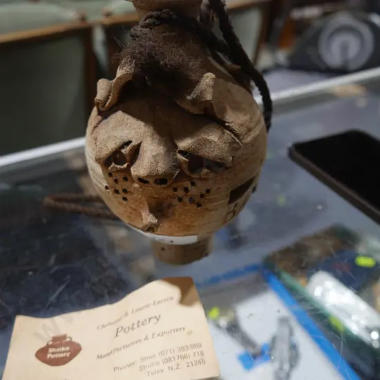Pottery piggy bank and coins