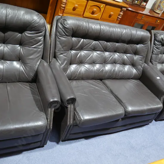 Brown three-piece leather lounge suite