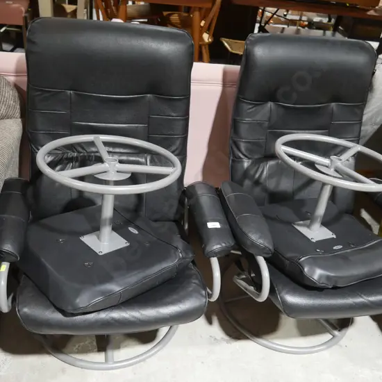 Two black leather chairs with stools