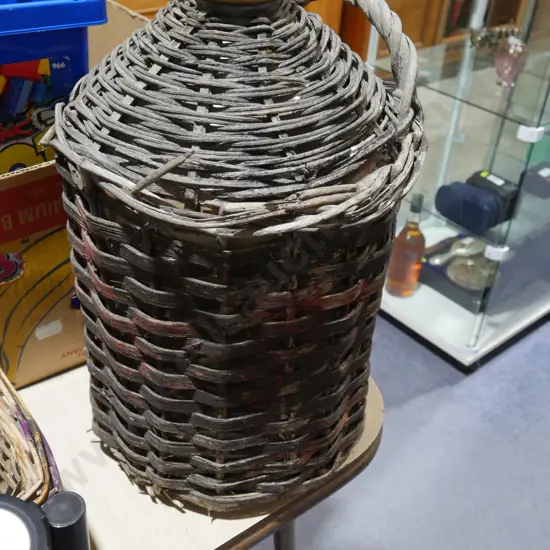 Cane covered stone bottle