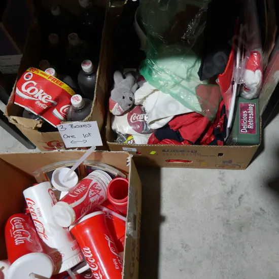 Three boxes of Coca-Cola memorabilia
